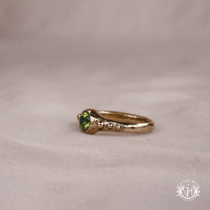 Star Cluster Ring with peridot and surrounding bead details in handcrafted metal