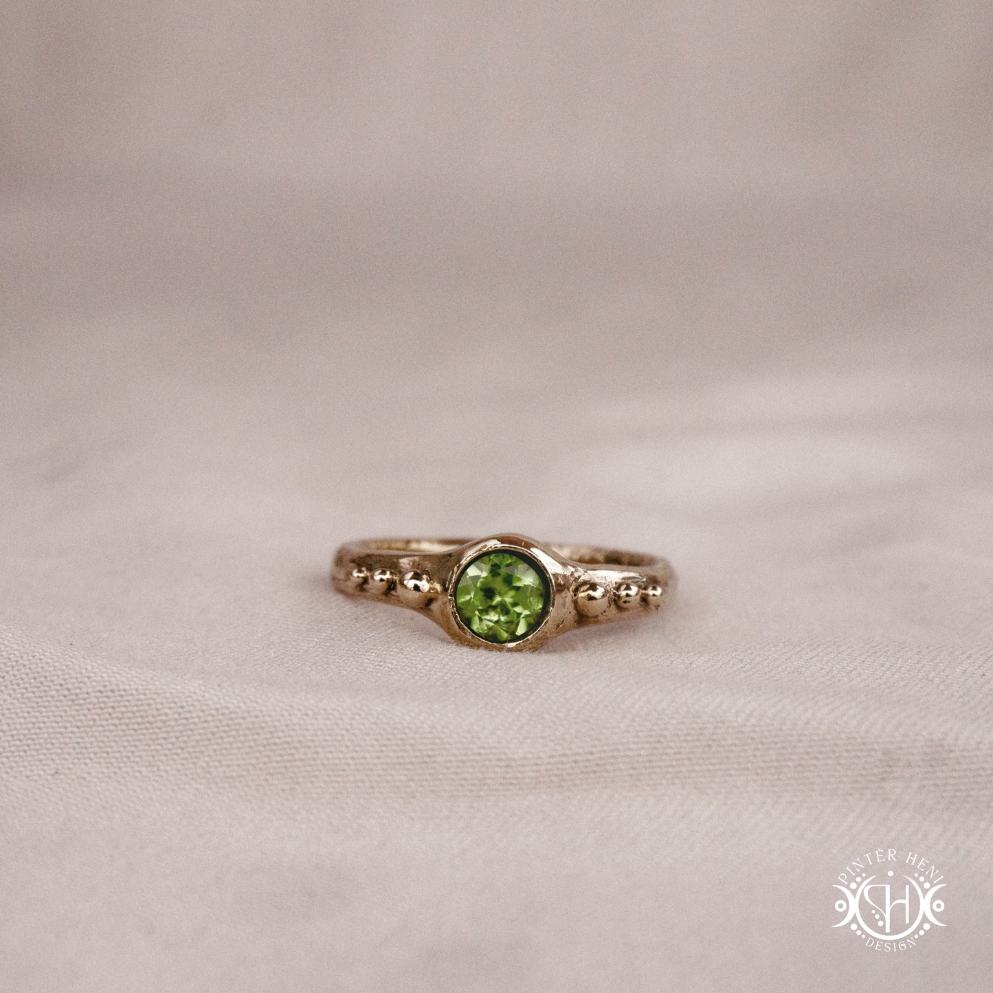 Star Cluster Ring with peridot and surrounding bead details in handcrafted metal