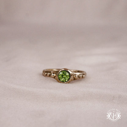 Star Cluster Ring with peridot and surrounding bead details in handcrafted metal