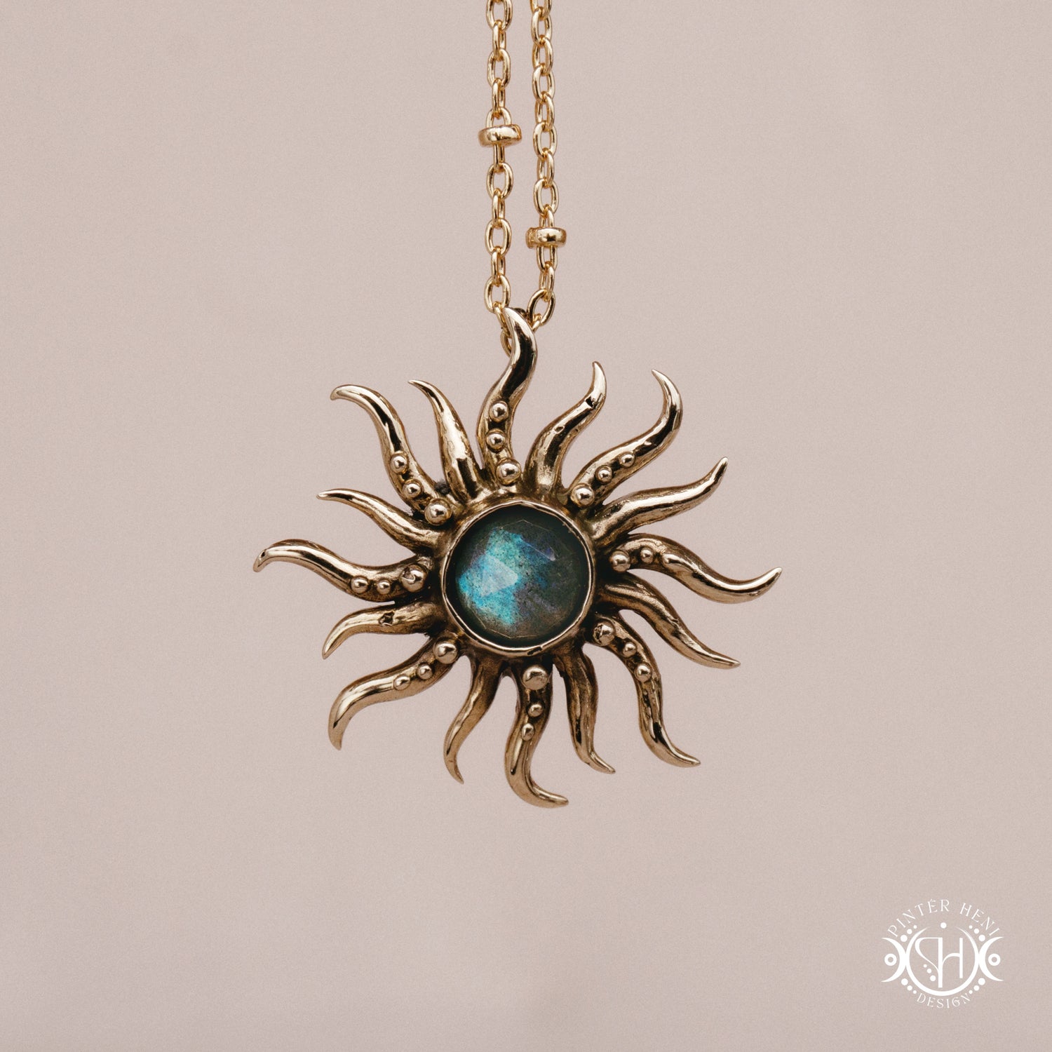 Hand-carved sun pendant in brass with organic rays from the Primal Symbols collection