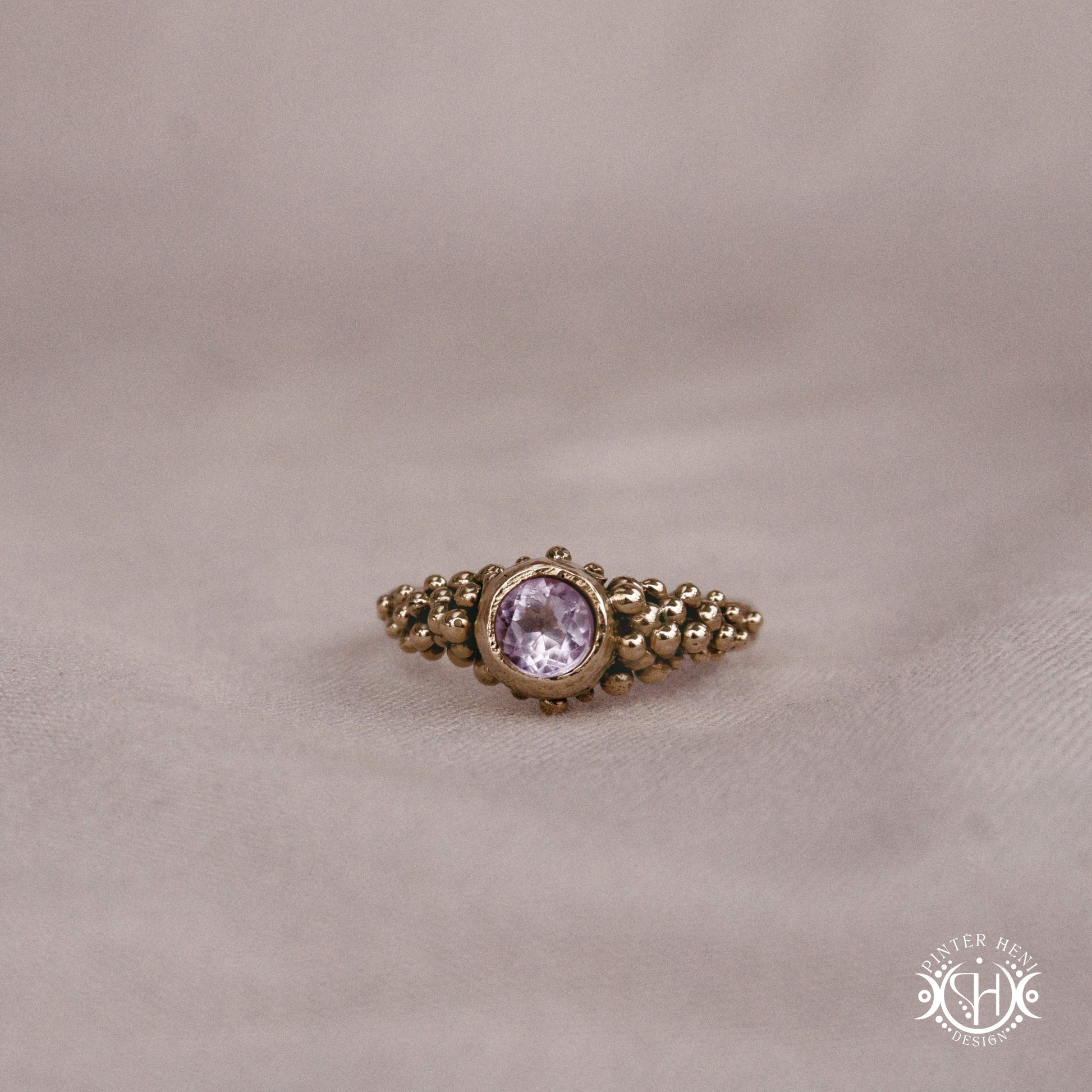Supernova Ring with clustered bead texture forming an upper arc in handcrafted metal