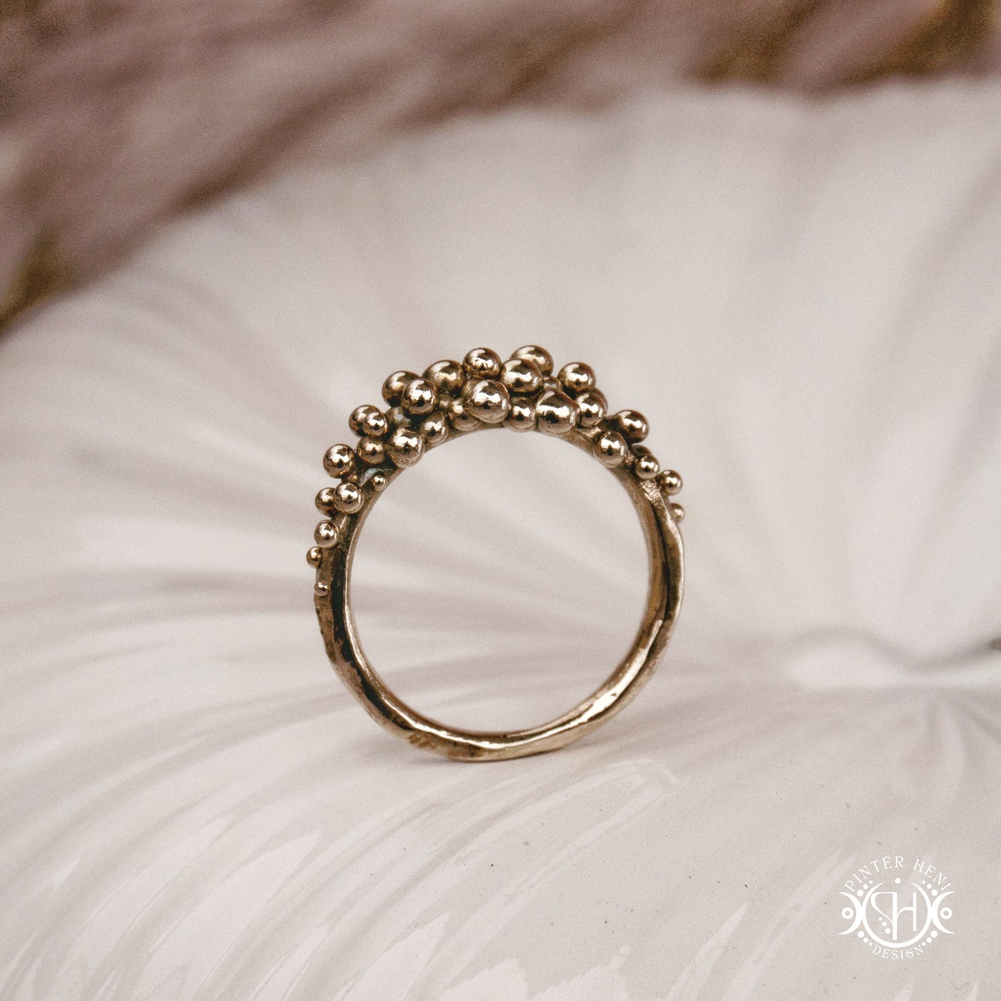 Supernova Ring with clustered bead texture forming an upper arc in handcrafted metal