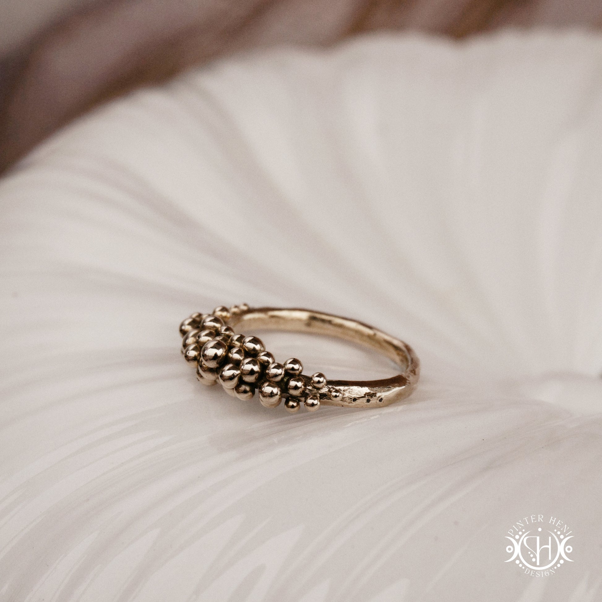 Supernova Ring with clustered bead texture forming an upper arc in handcrafted metal